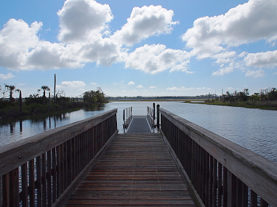 [Wooden dock leading to an aluminum dock all in the water.]